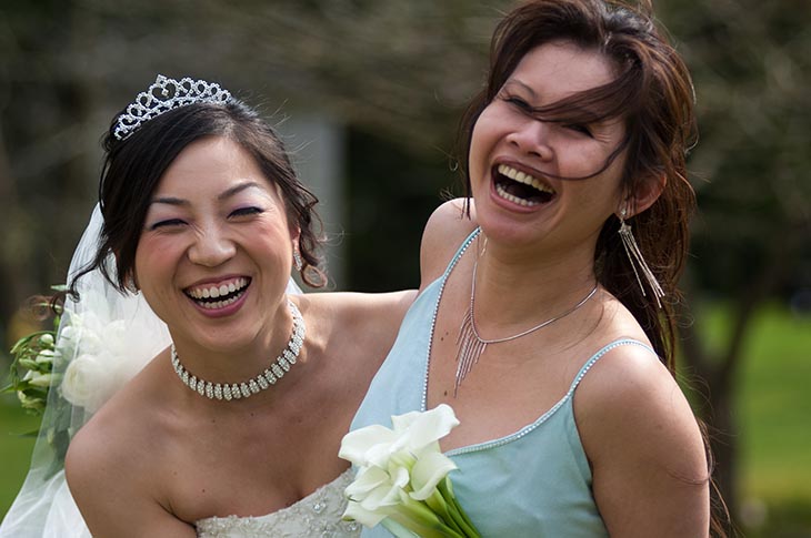 Bride & Bridesmaid laughing informally